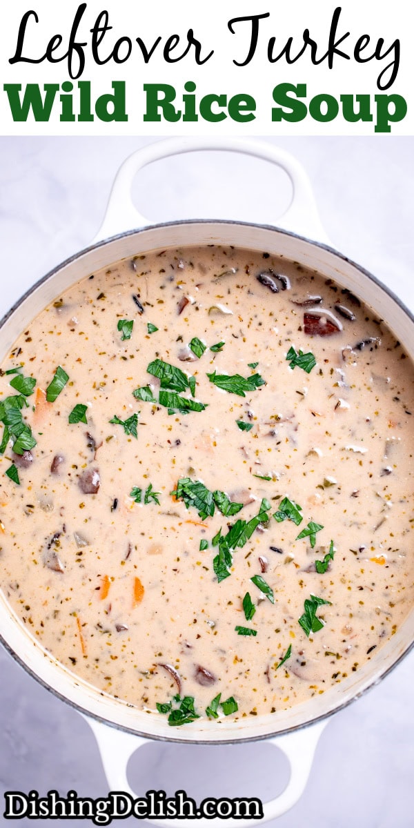 Pinterest pin with delicious homemade creamy leftover turkey and wild rice soup garnished with fresh parsley in a dutch oven.
