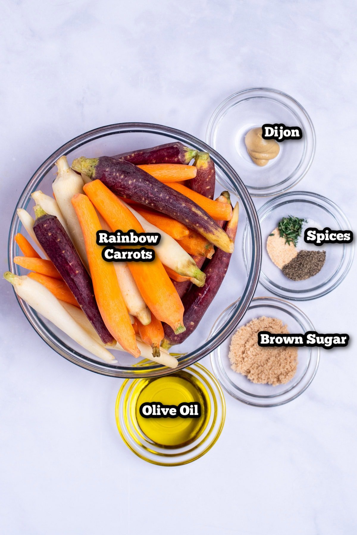 Individual ingredients for roasted rainbow carrots on a table.