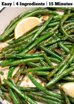 Pinterest pin with a sauté pan with cooked green beans with olive oil, salt, and pepper, and three lemon wedges resting on top.