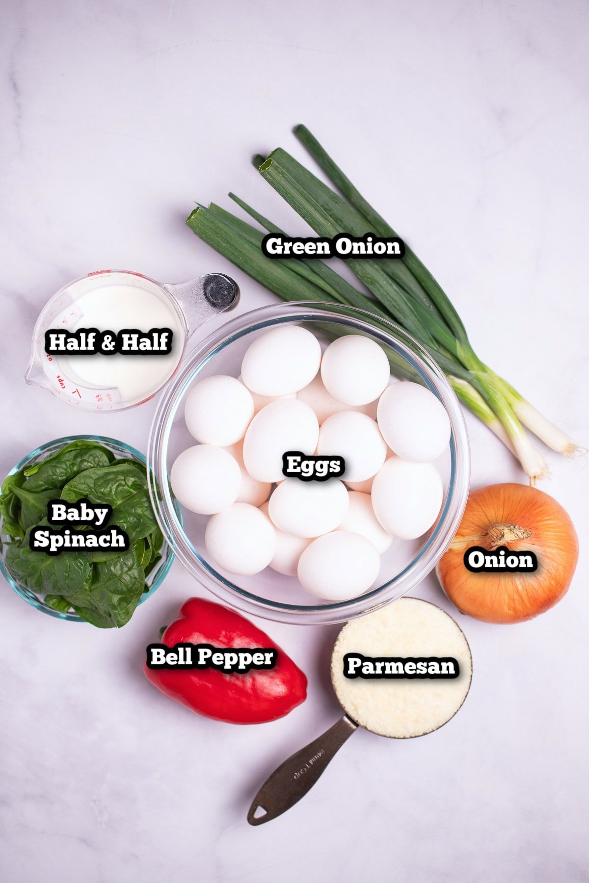 Individual ingredients for sheet pan eggs on a table.