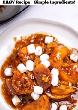 Pinterest pin with a plate of candied sweet potatoes sitting in a sugar sauce with mini marshmallows on top.
