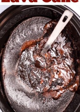 Pinterest pin with a slow cooker of chocolate lava cake with a spoon in it.