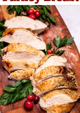 Pinterest pin with a cutting board with sliced turkey breast next to parsley and cranberries.