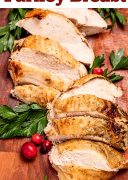 Pinterest pin with a cutting board with sliced turkey breast next to parsley and cranberries.