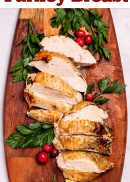 Pinterest pin with a cutting board with sliced turkey breast next to parsley and cranberries.