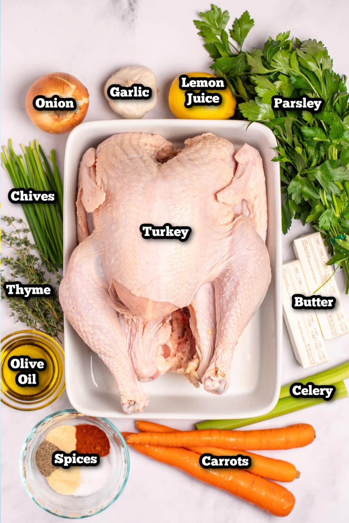 Individual ingredients for a roasted spatchcocked turkey on a table.