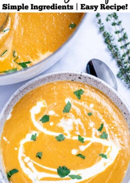 Pinterest pin with a bowl of creamy sweet potato soup topped with a drizzle of cream and chopped fresh cilantro, on a table next to a spoon and a sprig of fresh thyme, with a dutch oven of soup in the background.