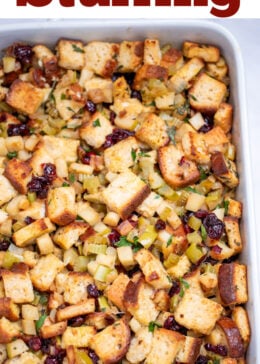 Pinterest pin with a baking dish full of gluten free stuffing on a table.