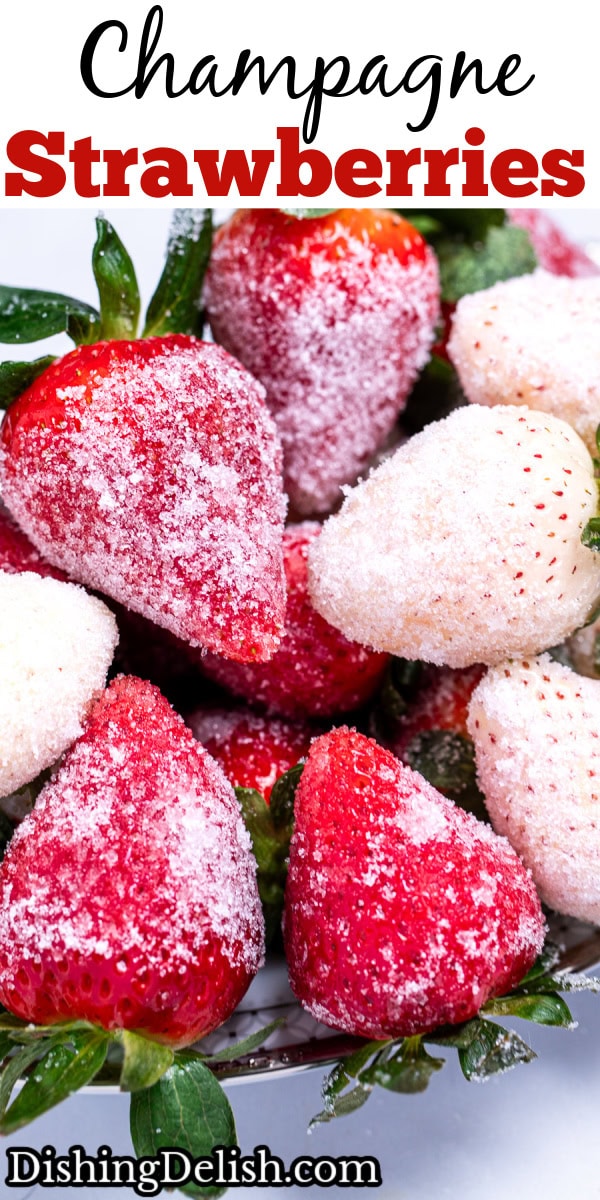 Red and white sugar coated champagne strawberries on a plate.