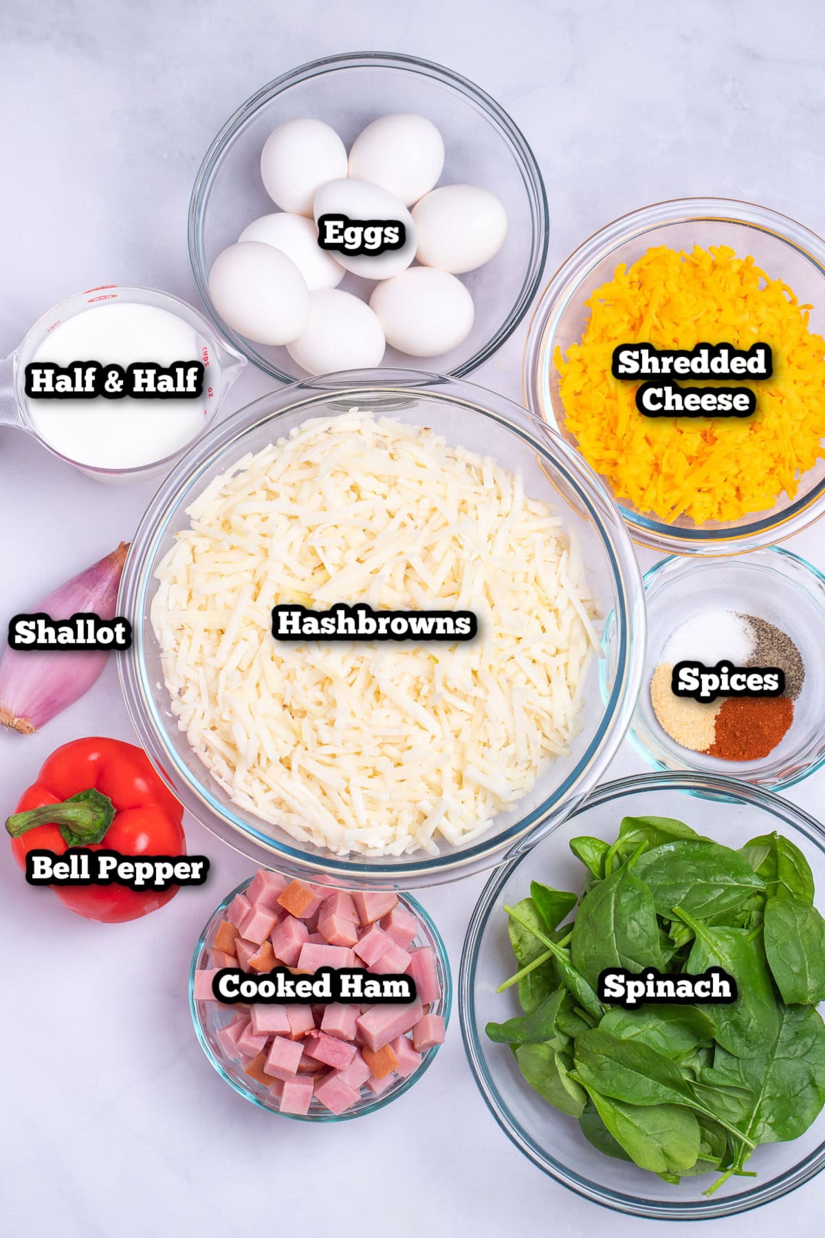 Individual ingredients for hashbrown breakfast casserole on a table.