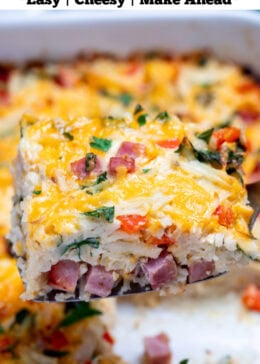 Pinterest pin with a casserole dish with hashbrown breakfast casserole topped with melted cheese and fresh parsley, with a spatula lifting a piece up.