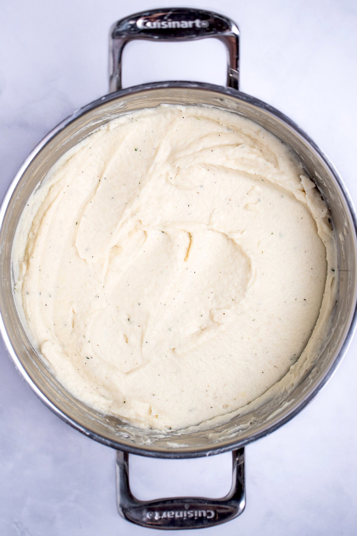 A pot with pureed parsnips on a table.