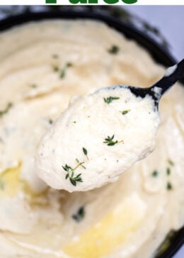 Pinterest pin with a bowl of parsnip puree topped with butter and thyme, next to fresh thyme on a table, and a spoon lifting some up.
