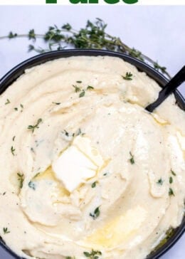 Pinterest pin with a bowl of parsnip puree topped with butter and thyme, next to fresh thyme on a table.