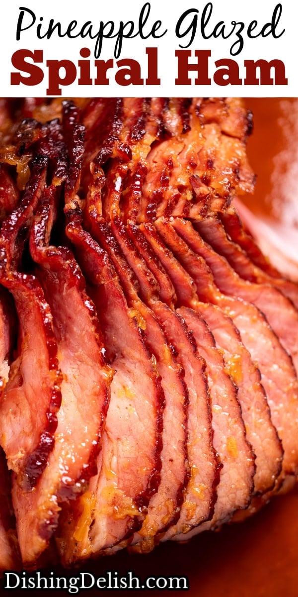 Pinterest pin with a spiral ham with a pineapple glaze with a caramelized top on a roasting pan with juices.