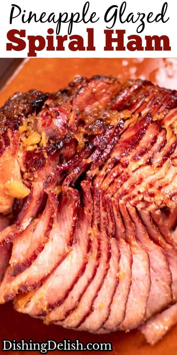 Pinterest pin with a spiral ham with a pineapple glaze with a caramelized top on a roasting pan with juices.