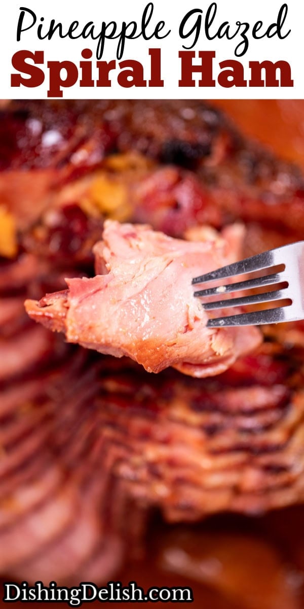 Pinterest pin with a spiral ham with a pineapple glaze with a caramelized top on a roasting pan with juices, with a fork lifting a piece up.