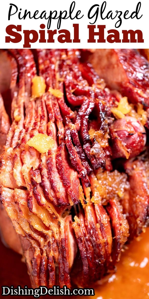 Pinterest pin with a spiral ham with a pineapple glaze with a caramelized top on a roasting pan with juices.