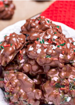 Pinterest pin with a bowl of chocolate peanut clusters topped with sprinkles.