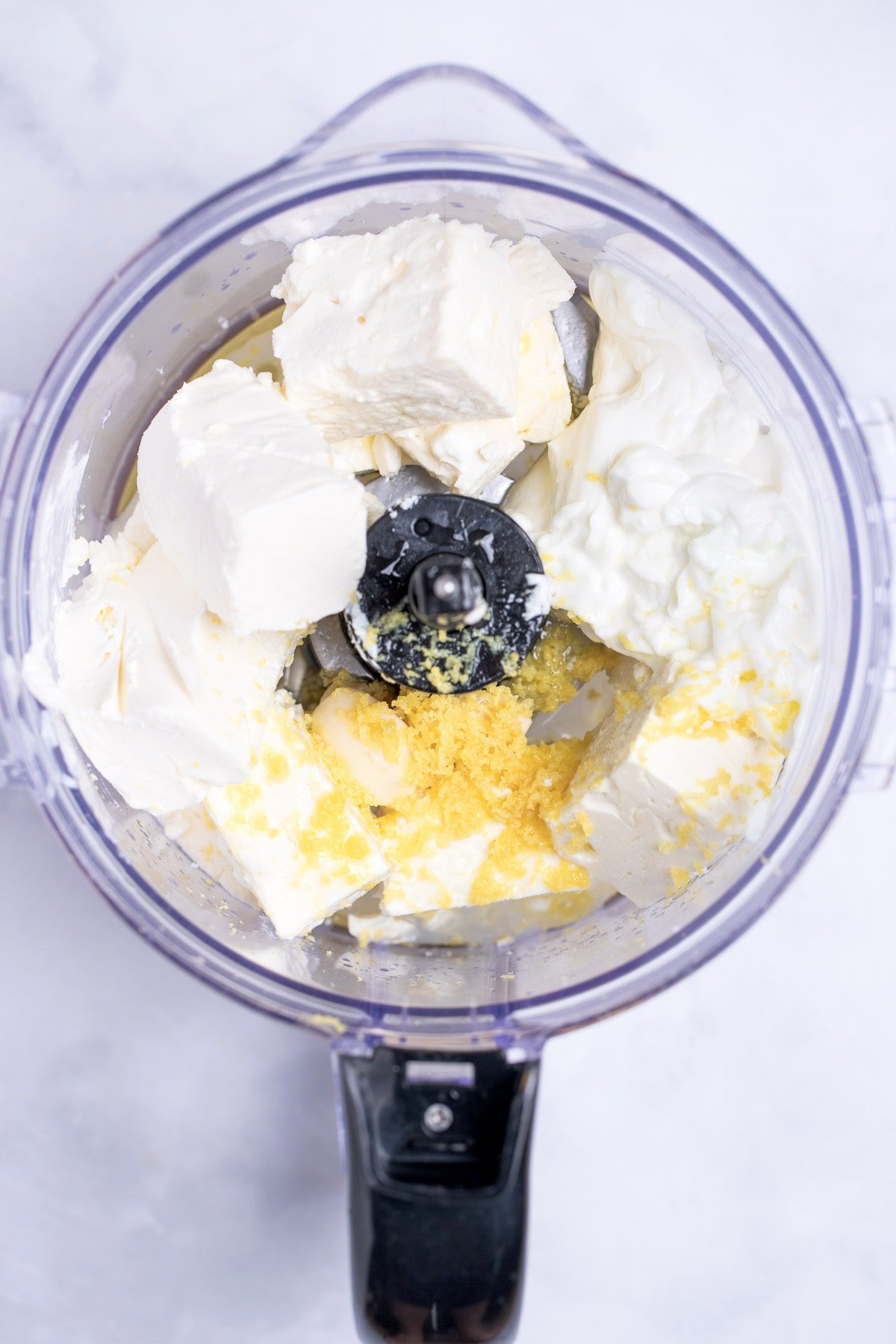 A food processor with all of the dip ingredients before being pureed.