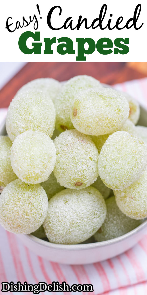 Pinterest pin with a bowl of sugared grapes on a tea towel on a wooden cutting board.