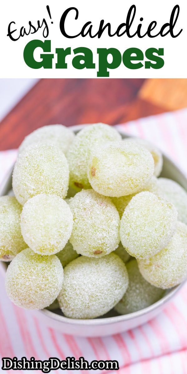 Pinterest pin with a bowl of sugared grapes on a tea towel on a wooden cutting board.