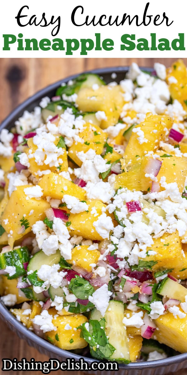 Pinterest pin with a bowl of pineapple cucumber salad topped with feta cheese sitting on a wooden cutting board.