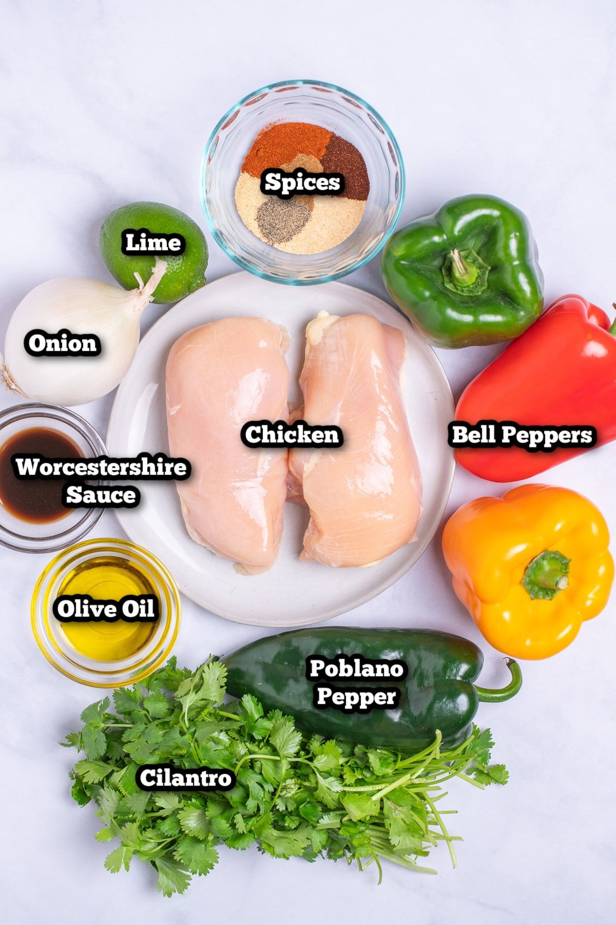 Individual ingredients for sheet pan chicken fajitas on a table.