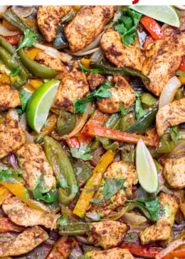 Pinterest pin with a sheet pan lined with parchment paper with cooked chicken and peppers topped with fresh cilantro.