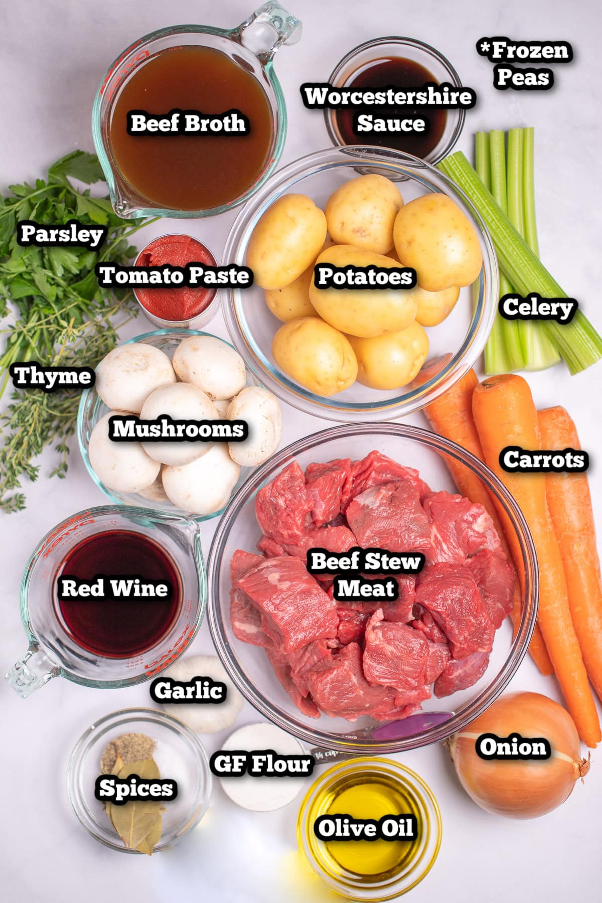 Individual ingredients for beef stew on a table.