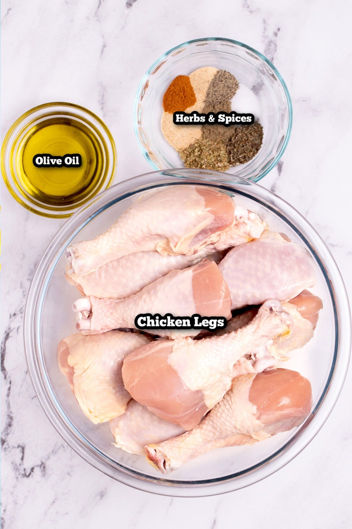 Individual ingredients for baked chicken legs on a table.