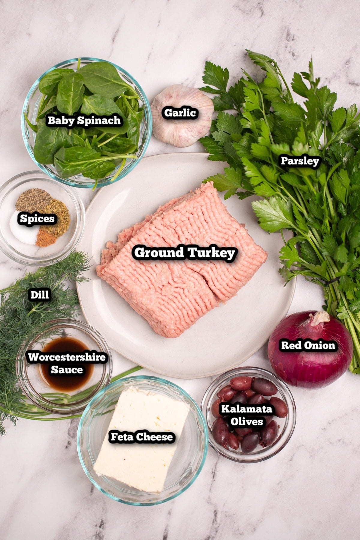 Individual ingredients for Greek Turkey Burgers on a table.
