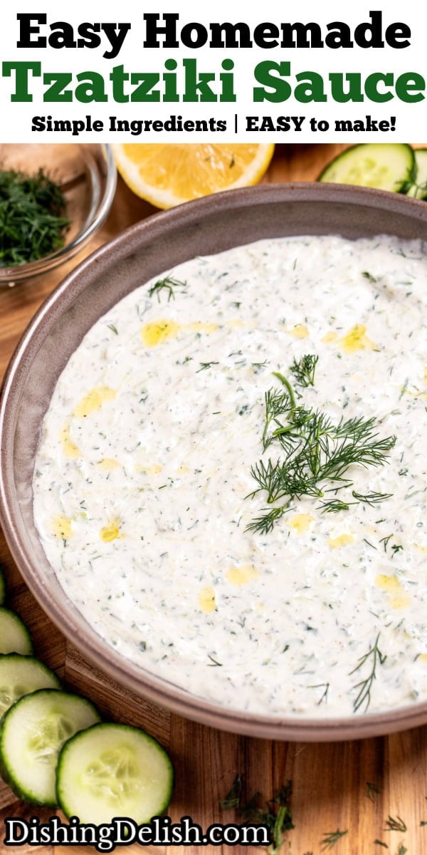 Pinterest pin with a bowl of homemade tzatziki sauce topped with fresh dill, on a cutting board with sliced cucumber, lemon, and a small bowl of chopped fresh dill.