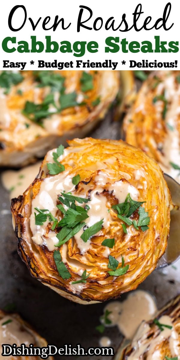 Pinterest pin with a sheet pan of roasted cabbage steaks topped with tahini dressing and chopped fresh parsley, with a spatula lifting one up.