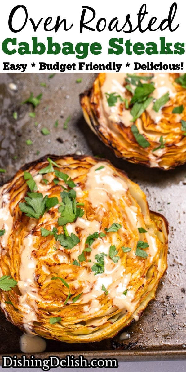 Pinterest pin with a sheet pan of roasted cabbage steaks topped with tahini dressing and chopped fresh parsley.