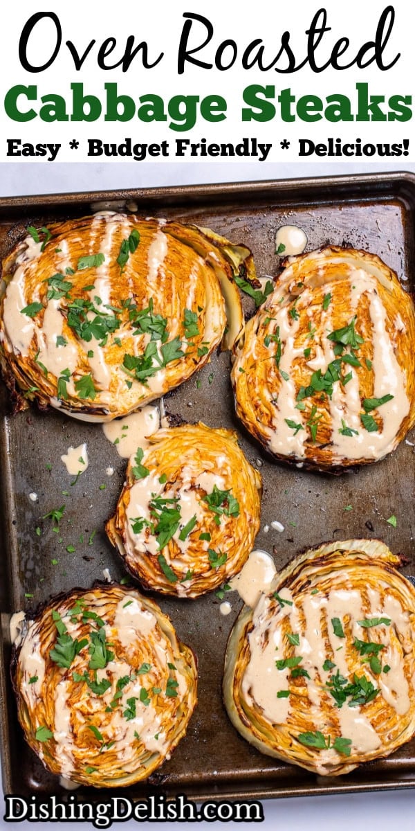 Pinterest pin with a sheet pan of roasted cabbage steaks topped with tahini dressing and chopped fresh parsley.