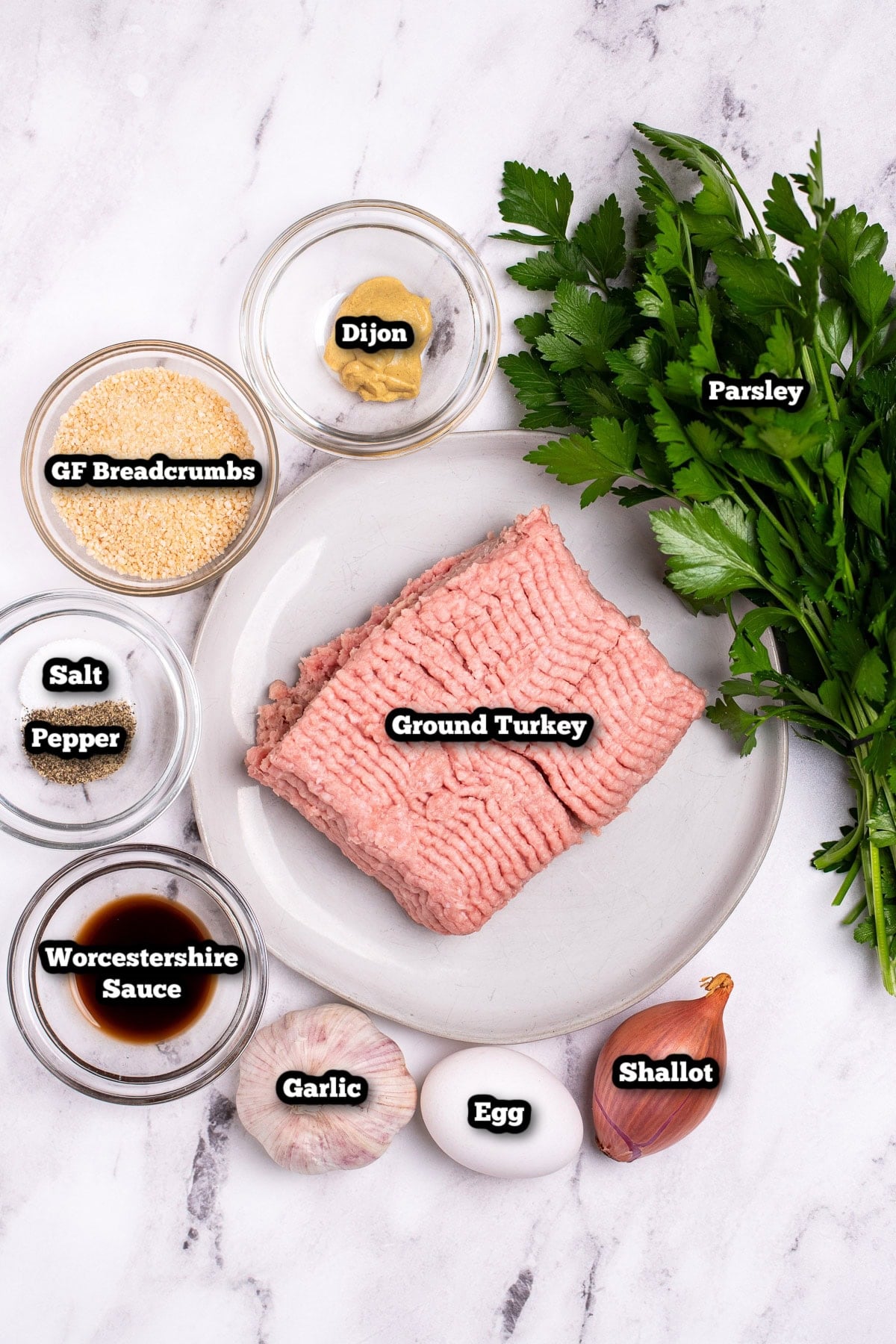 Individual ingredients for grilled turkey burgers on a table.