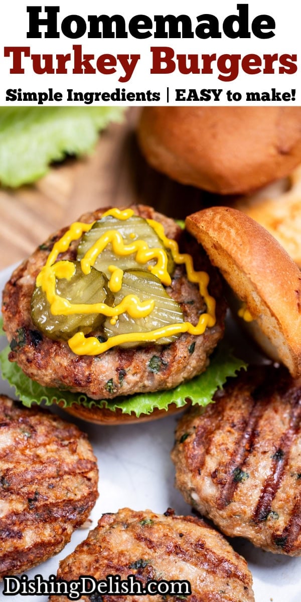 Pinterest pin with four turkey burgers with grill marks on a plate, one in a burger bun with lettuce, pickles, and mustard, resting on a wooden cutting board, next to lettuce and a hamburger bun.