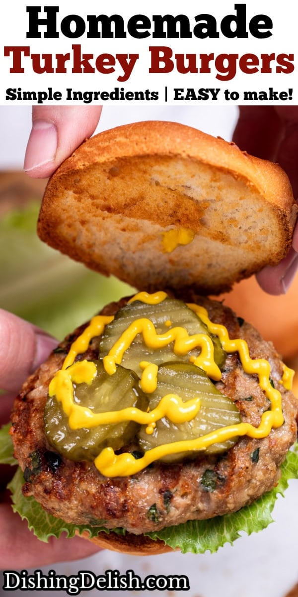 Pinterest pin with two hands holding a grilled turkey burger with lettuce, pickles, and mustard, lifting the top bun piece up.