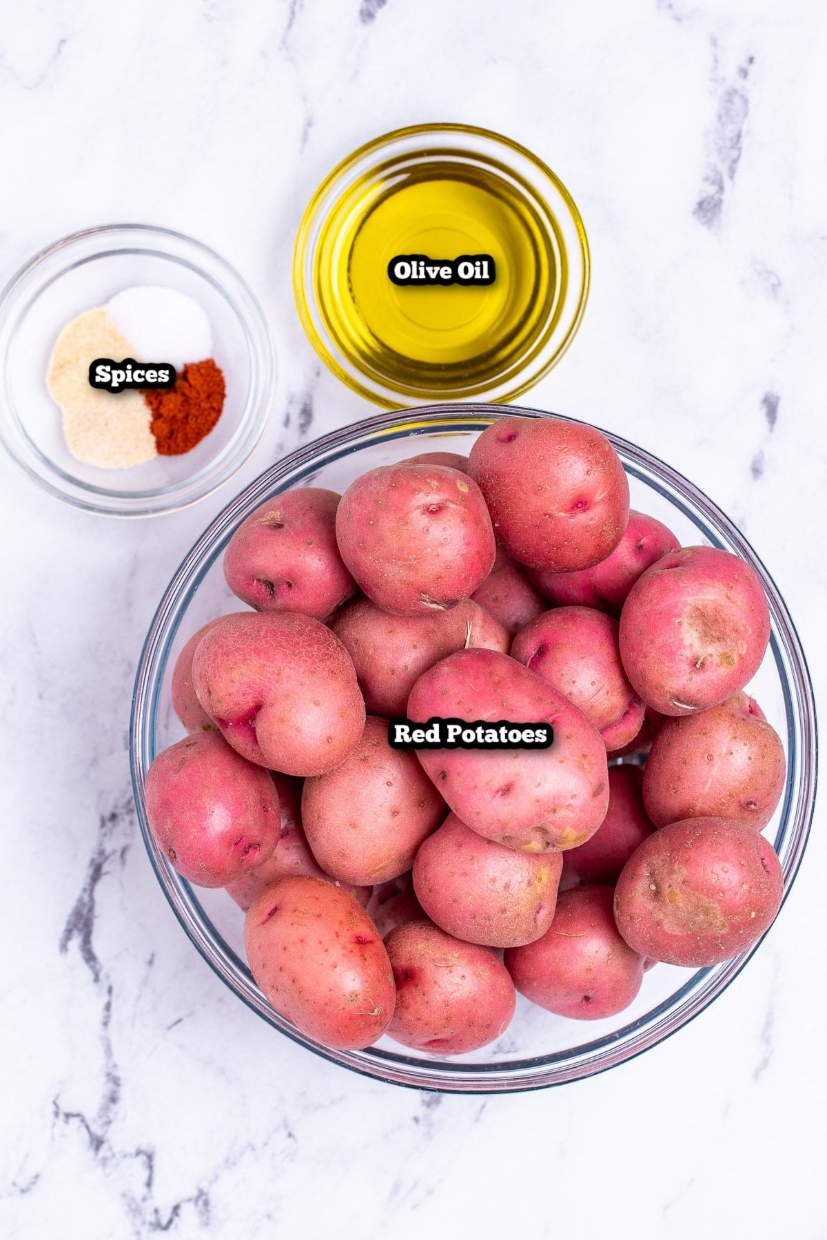 Individual ingredients for oven roasted red potatoes on a table.