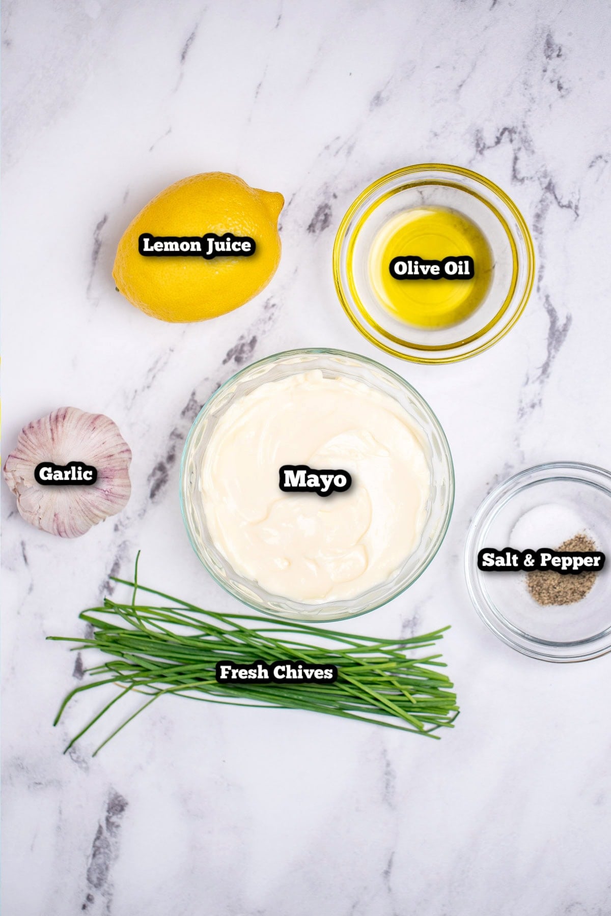 Individual ingredients for Roasted Garlic Aioli on a table.