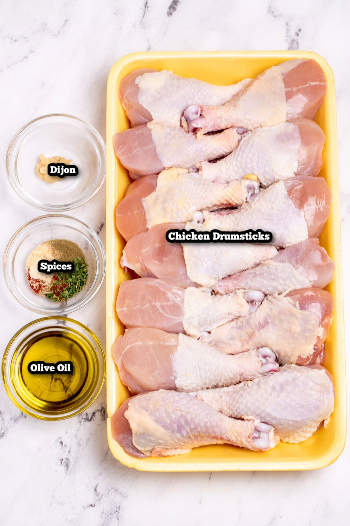Individual ingredients for slow cooker chicken legs on a table.