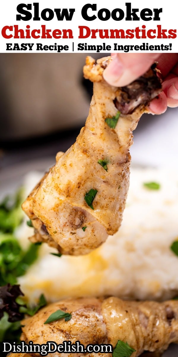 Pinterest pin with a hand holding a chicken drumstick over a plate with another drumstick, salad, and mashed potatoes.