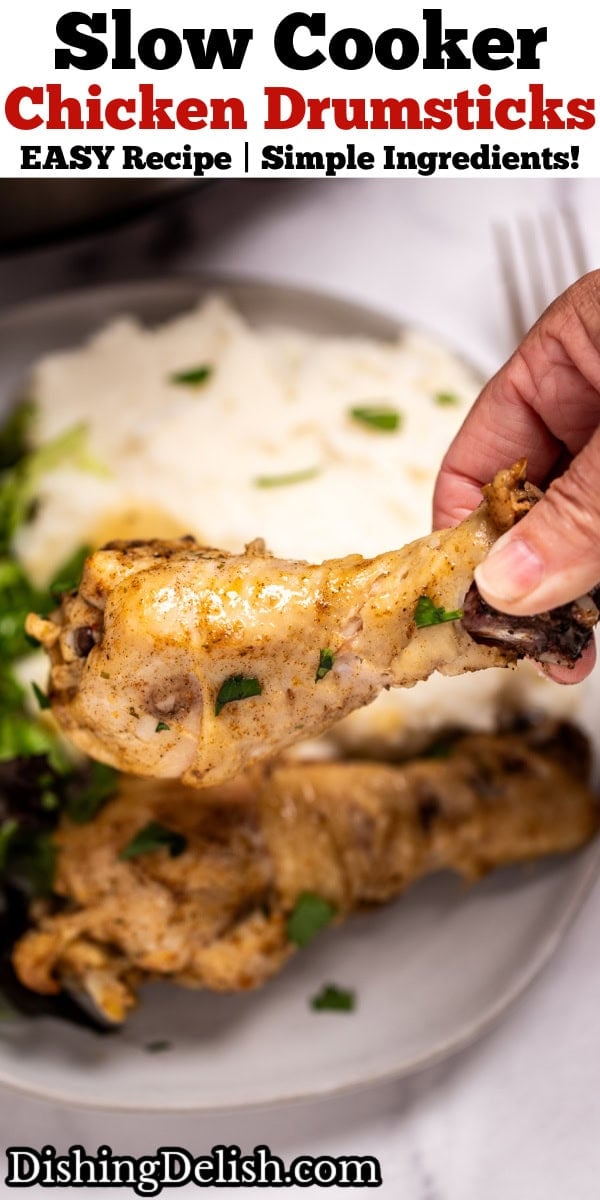 Pinterest pin with a hand holding a chicken drumstick over a plate with another drumstick, salad, and mashed potatoes.
