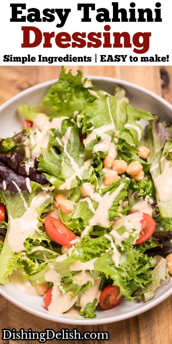 Pinterest pin with a salad with lettuce, cherry tomatoes, and chickpeas topped with lemon tahini dressing in a bowl on a cutting board.