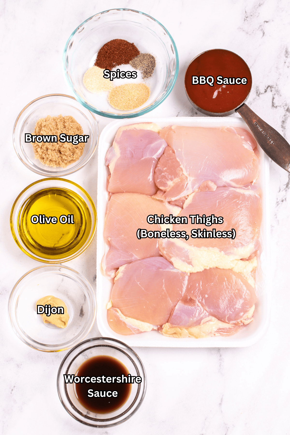 Individual ingredients for bbq grilled chicken thighs on a table.