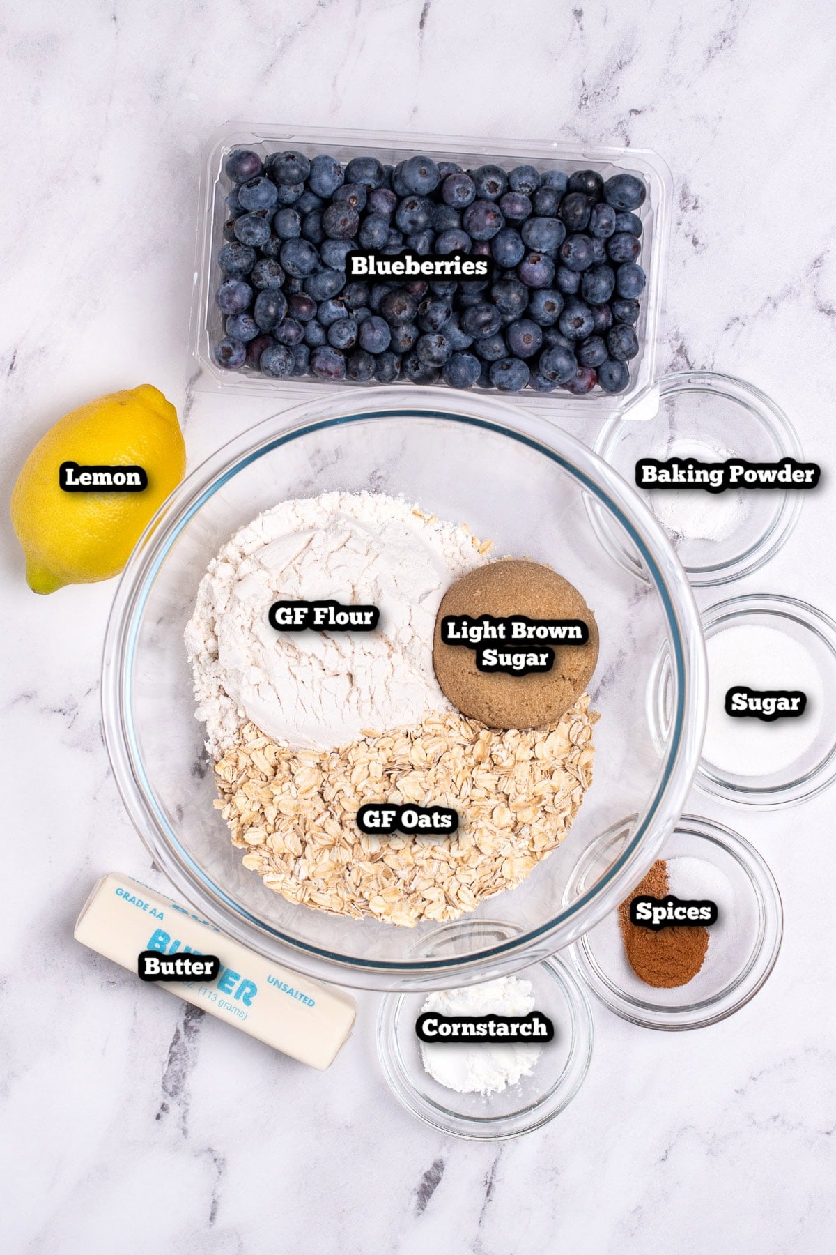 Individual ingredients for blueberry oatmeal bars on a table.