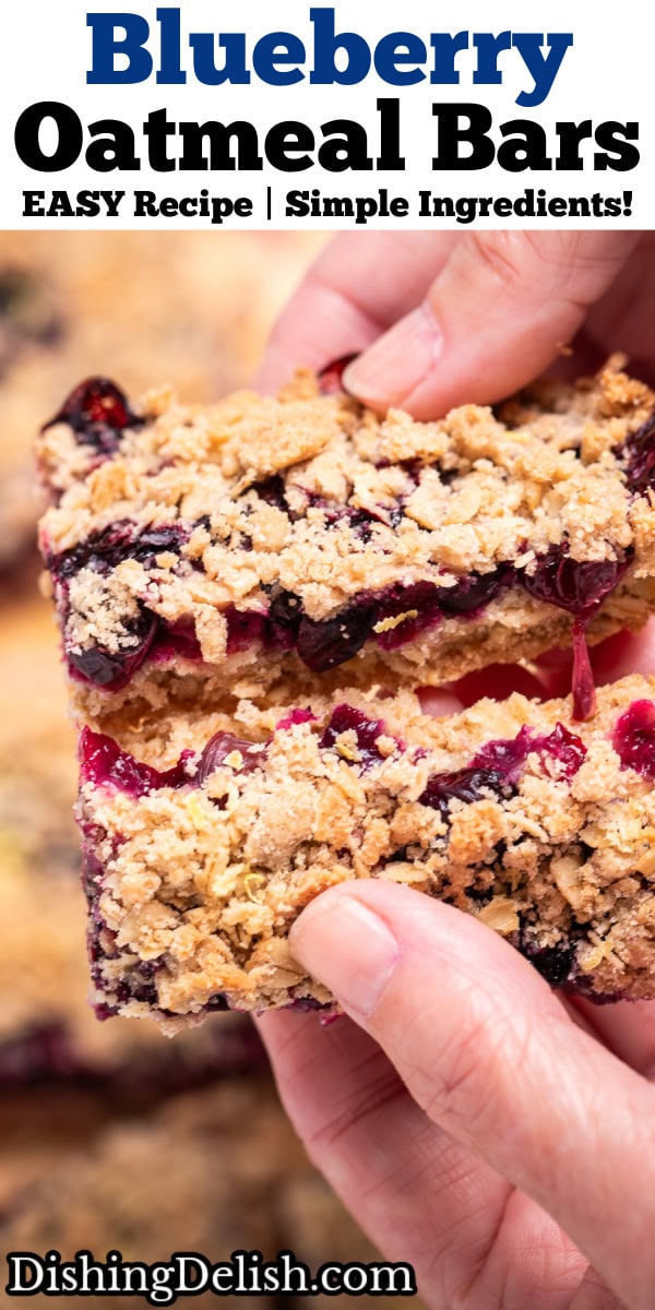 Pinterest pin with two hands breaking a blueberry oatmeal bar in half to show the middle blueberry layer, above more bars.