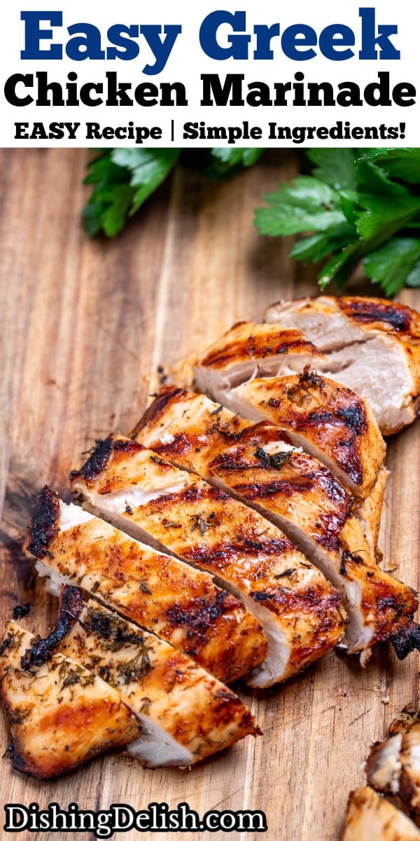 Pinterest pin with a sliced Greek marinated chicken breast resting on a cutting board next to fresh parsley.
