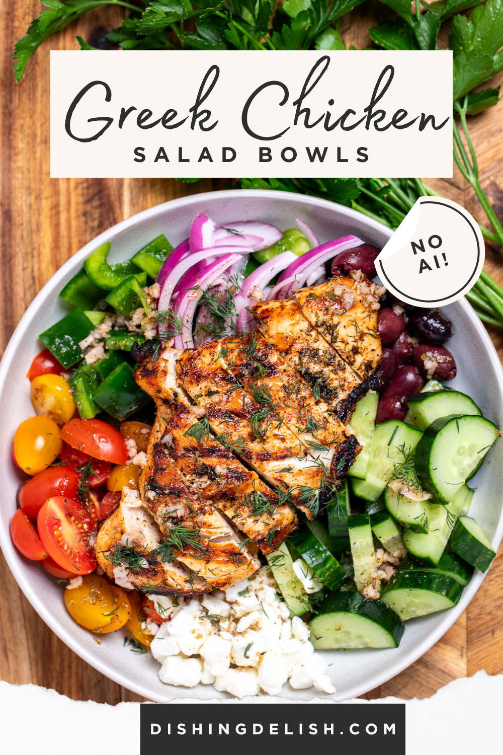 Pinterest pin with a bowl with vegetables, feta, olives, and sliced grilled chicken topped with fresh dill sitting on a cutting board, in front of fresh parsley.